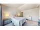 This bright bedroom features gray carpeting, a queen size bed and neutral-colored walls at 7700 W Grant Ranch Blvd # 4A, Littleton, CO 80123