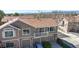Aerial view of townhome featuring a private balcony and attached garages at 7700 W Grant Ranch Blvd # 4A, Littleton, CO 80123