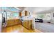 Bright eat-in kitchen has wooden cabinets, hardwood flooring, stainless steel appliances and a large window at 7700 W Grant Ranch Blvd # 4A, Littleton, CO 80123