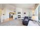 Spacious living room featuring a fireplace, TV, and open layout to kitchen at 7700 W Grant Ranch Blvd # 4A, Littleton, CO 80123