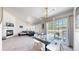 Spacious open-concept living and dining area, with modern lighting at 7700 W Grant Ranch Blvd # 4A, Littleton, CO 80123
