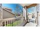 Charming covered porch with white railings and pillars, offering shade and curb appeal at 7700 W Grant Ranch Blvd # 4A, Littleton, CO 80123