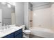 Modern bathroom featuring blue vanity, tile floors and a shower-tub combination at 7090 Simms St # 202, Arvada, CO 80004