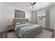Relaxing primary bedroom with a ceiling fan, neutral decor, and a large window providing plenty of natural light at 7090 Simms St # 202, Arvada, CO 80004