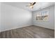 Bright bedroom featuring a ceiling fan, modern flooring and a window offering natural light and neighborhood views at 7090 Simms St # 202, Arvada, CO 80004