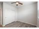 Minimalist bedroom with new flooring featuring a ceiling fan, built-in closet and natural light at 7090 Simms St # 202, Arvada, CO 80004
