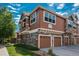 Beautiful multi-story townhouse with stone and siding and two-car garages at 7090 Simms St # 202, Arvada, CO 80004