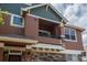 Two-story unit with charming balcony, stone accents, and neutral siding at 7090 Simms St # 202, Arvada, CO 80004