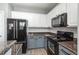 Well-equipped kitchen featuring stainless steel appliances, granite counters, and two-tone cabinetry at 7090 Simms St # 202, Arvada, CO 80004