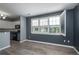 Sunlit room with large windows, open blinds, and views to the kitchen at 7090 Simms St # 202, Arvada, CO 80004
