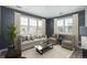 Cozy living room with neutral decor, large windows, and comfortable seating area at 7090 Simms St # 202, Arvada, CO 80004
