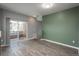 Open-concept living space with sliding glass doors to a balcony at 7090 Simms St # 202, Arvada, CO 80004