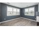 Bright living room with large windows and wood-look flooring; a blank canvas for your design at 7090 Simms St # 202, Arvada, CO 80004