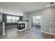 Open concept living area featuring a fireplace and sliding door to an outdoor space at 7090 Simms St # 202, Arvada, CO 80004