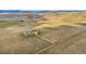 Expansive aerial view showcases a home with a barn in the distance at 12747 Bestview Dr, Larkspur, CO 80118