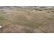 An open field with houses and mountain views in the distance at 12747 Bestview Dr, Larkspur, CO 80118