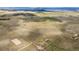 Sweeping aerial shot of grassy plains with scattered houses and roadways at 12747 Bestview Dr, Larkspur, CO 80118