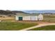 Spacious barn with a green roof and sliding door at 12747 Bestview Dr, Larkspur, CO 80118