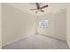 Bedroom featuring neutral carpet, a ceiling fan, and bright window with natural light at 12747 Bestview Dr, Larkspur, CO 80118
