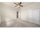 Bedroom featuring neutral carpet, a ceiling fan, double-door closet and white walls at 12747 Bestview Dr, Larkspur, CO 80118