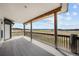 Covered wood deck with railing showcases expansive views of the surrounding landscape at 12747 Bestview Dr, Larkspur, CO 80118