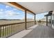 Covered wood deck showcasing expansive views of the surrounding landscape at 12747 Bestview Dr, Larkspur, CO 80118