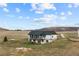 A charming exterior view of the two-story home showcasing the surrounding land and beautiful hillside views at 12747 Bestview Dr, Larkspur, CO 80118