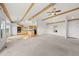 Open concept living room with vaulted ceiling, exposed beams, and kitchen view at 12747 Bestview Dr, Larkspur, CO 80118