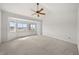 Bright main bedroom with vaulted ceilings, ceiling fan, and door to outside at 12747 Bestview Dr, Larkspur, CO 80118