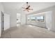 Bright main bedroom with vaulted ceilings, ceiling fan, and a large window at 12747 Bestview Dr, Larkspur, CO 80118