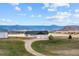 Stunning exterior view of property featuring house and barn with mountain views and fenced yard at 12747 Bestview Dr, Larkspur, CO 80118