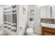 Clean and modern bathroom with shower/tub combo, white toilet, and decorative wall art at 7395 E Quincy Ave # 206, Denver, CO 80237