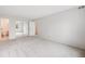 Spacious bedroom featuring neutral carpet, white walls, and mirrored closet doors at 7395 E Quincy Ave # 206, Denver, CO 80237