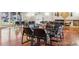 Community room with fireplace, laminate floors, tables, and chairs at 7395 E Quincy Ave # 206, Denver, CO 80237