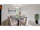 Bright dining room featuring a glass-top table with seating for six, modern lighting, and neutral decor at 7395 E Quincy Ave # 206, Denver, CO 80237