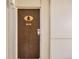 Image of wooden apartment door with unit number 206 and tree symbol at 7395 E Quincy Ave # 206, Denver, CO 80237