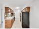 Spacious kitchen featuring stainless steel appliances, wooden cabinetry, and a tile backsplash at 7395 E Quincy Ave # 206, Denver, CO 80237