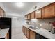 Spacious kitchen with stainless steel sink, granite countertops and wooden cabinetry at 7395 E Quincy Ave # 206, Denver, CO 80237