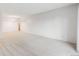 Open-concept living room featuring white walls, neutral carpet, and elegant chandelier lighting at 7395 E Quincy Ave # 206, Denver, CO 80237