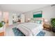 Bright main bedroom with neutral carpet, white walls, and a large window view at 7395 E Quincy Ave # 206, Denver, CO 80237