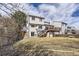 Exterior view of a multi-story home, showcasing a deck, backyard, and surrounding landscaping at 10408 Strasburg Way, Parker, CO 80134