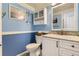 Stylish half-bathroom with blue walls, decorative accents, and a granite countertop vanity at 10408 Strasburg Way, Parker, CO 80134