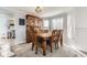 Dining room featuring a wood table and chairs, a china cabinet, and large windows at 10408 Strasburg Way, Parker, CO 80134