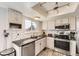 Modern kitchen featuring white cabinets, granite countertops, subway tile backsplash, and stainless steel appliances at 10408 Strasburg Way, Parker, CO 80134