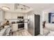 Modern kitchen featuring white cabinets, granite countertops, stainless steel appliances, and an open floor plan at 10408 Strasburg Way, Parker, CO 80134