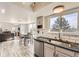 Bright and airy kitchen featuring white cabinets, granite countertops, and stainless steel appliances at 10408 Strasburg Way, Parker, CO 80134