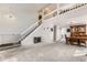 Spacious living room with soaring ceilings and a staircase leading to the upper level, adjacent to dining area at 10408 Strasburg Way, Parker, CO 80134