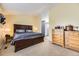 Spacious main bedroom with neutral carpet and dark wood furniture, leading to a private bathroom at 10408 Strasburg Way, Parker, CO 80134