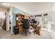 Bright home office with built-in wooden desk, shelving, and two windows providing natural light at 10408 Strasburg Way, Parker, CO 80134