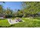 A relaxing picnic area with tables surrounded by lush green lawns and mature trees at 10408 Strasburg Way, Parker, CO 80134